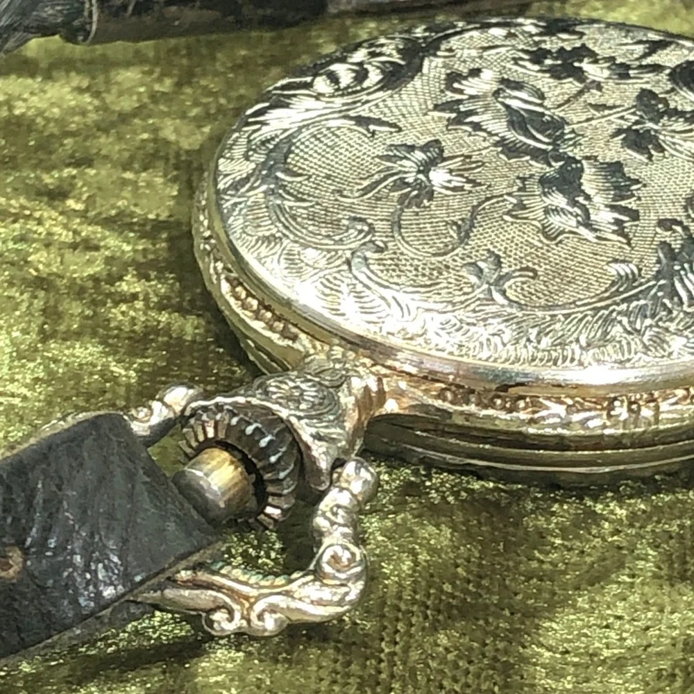 Silver-Tone Pocket Watch with Black Leather Strap man fishing
